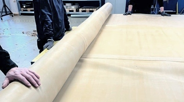 The finished rubber crane is carefully rolled up before being shipped to the customer.